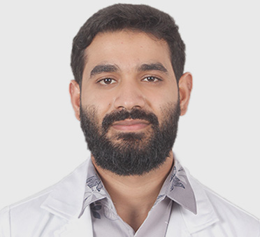 Dr. Sadik Hassan Roy, a confident younger male doctor